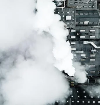 Top down view over a large factory in smoke and steam. 스톡 사진