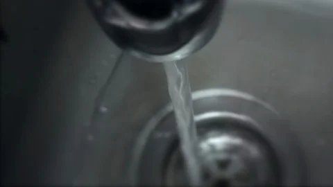 Top down view over stainless steel sink with running water from tap Stock Footage 104782112