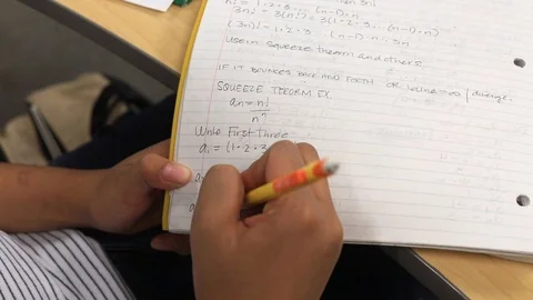 Top down view over student working on solving maths problem calculations Stock Footage 123089557