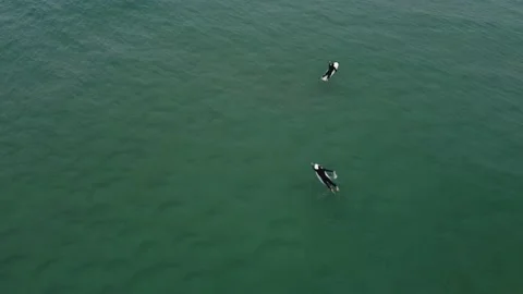 Top down view over surfers paddling in playa de Gerra, Cantabria, Spain 4K Stock Footage 155592945