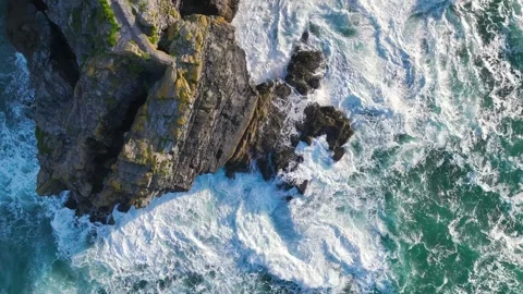 Top Down view over Waves and Cliffs from a drone, Cornwall, England Stock-Footage 247935328