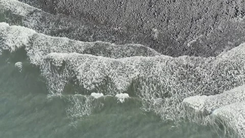 Top Down view over Waves and Stone Beach from a drone, Devon, England, Europe 動画素材 250492020