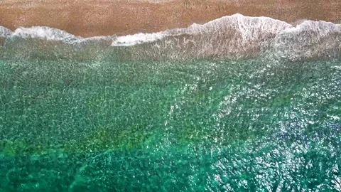 Top-down view of paradise pebble beach and crystal clear water. Rhodes, Greece Stock Footage 310266388