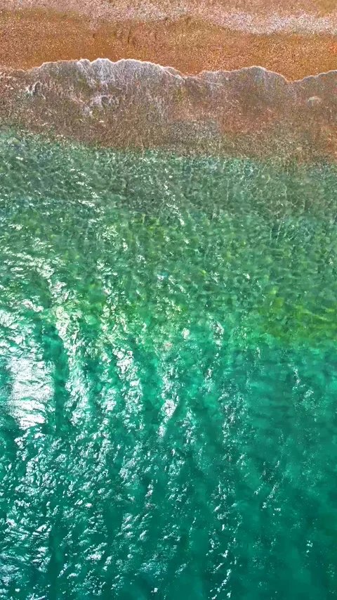 Top-down view of paradise pebble beach and crystal clear water. Rhodes, Greece Stock Footage 342957154