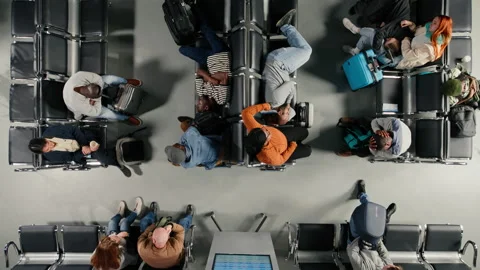 Top down view of passengers in airport resting on benches after delayed flight Video stock 333649442