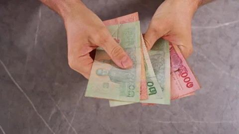 Top Down View of Person Counting Thai Baht Banknotes by Hand on a Table, Close U Stock Footage 339207062
