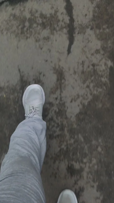 Top down view of person legs in grey pants and sneakers. Stock Footage 341603323