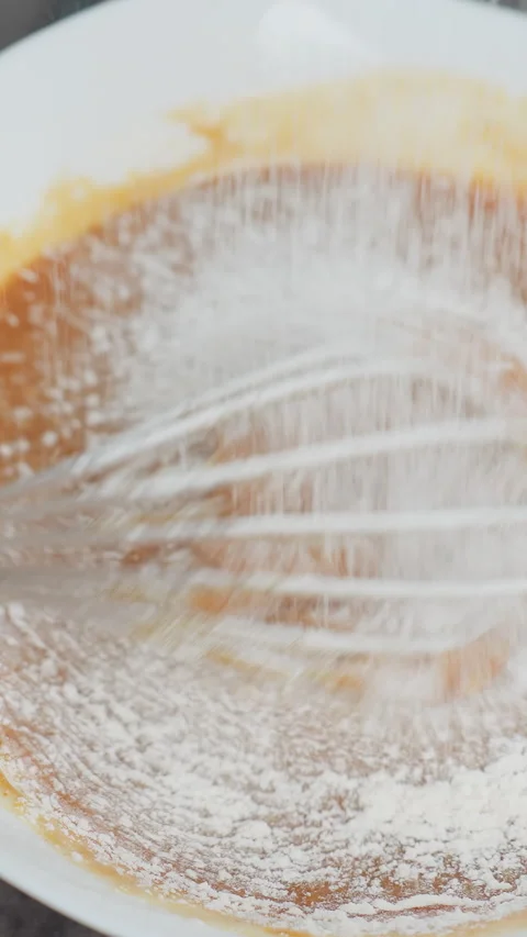 Top-Down View of Person Mixing Soup as White Corn Flour is Sifted In Stock Footage 320363197