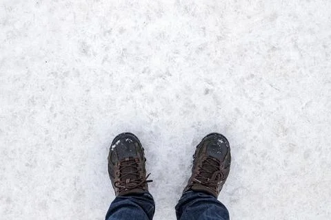 Top-down view of a person standing on white fozen ground 库存照片