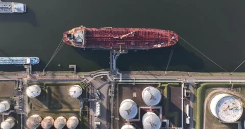 Top down view on petroleum ship loading and unloading terminal. Storage silos Stock Footage 305638553