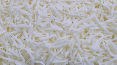 Top down view. Pile of grated mozzarella cheese in close detail.  Slider shot Video stock 296565413