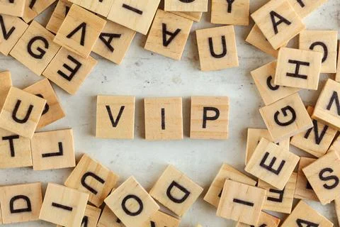 Top down view, pile of square wooden blocks with letters VIP (stands for Very Stock Photos