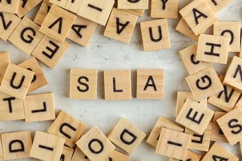 Top down view, pile of square wooden blocks with letters SLA (stands for Serv Stock Photos