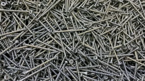 Top-Down View Of A Pile Of Steel Screws In Motion, Highlighting Their Texture An 스톡 동영상 309771982