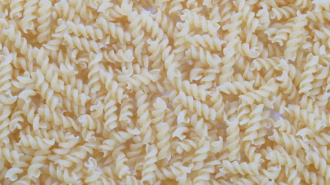 Top down view. Pile of uncooked Fusilli, italian spiral pasta. Slider shot. Stock Footage 296522501