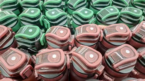 Top down view of pink and green plastic sports bottles Photos
