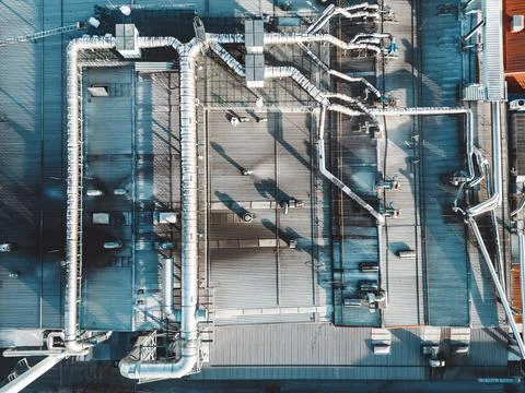 Top down view of pipes going across the roof top of logistics center Stock Photos