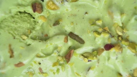 Top-Down View of Pistachio Ice Cream and Raw Pistachios Stock Footage 313546663