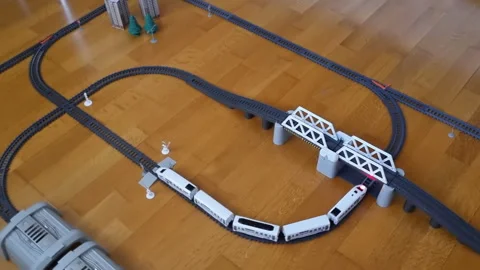 Top down view on plastic toy train riding railway. Childish Toy Railway. Stock Footage 276543014