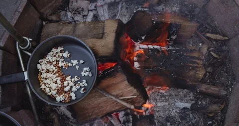 Top down view of Popcorn being cooked on open fire in saucepan in slow motion Stock Footage 98273308