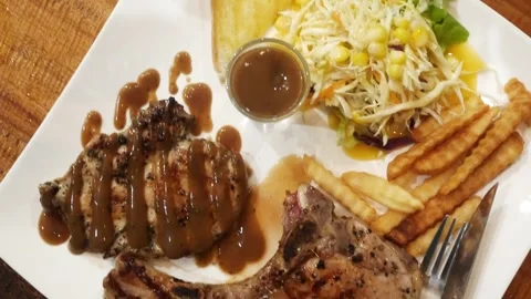 Top down view to porkchop and chicken steak in a plate serving in Thai styl.. Stock Footage 283630492