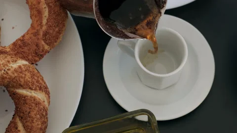 Top down view of pouring black turkish coffee into white cup standing on table Stock Footage 219636347