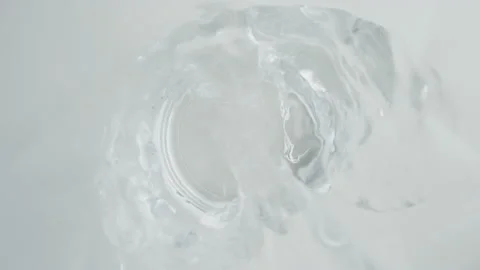 Top down view of pouring water into glass on white background, underwater lens Stock Footage 234150438