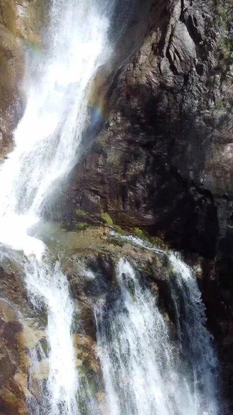 Top down view of powerful waterfall falling on wet rocks in green forest Stock Footage 336691428
