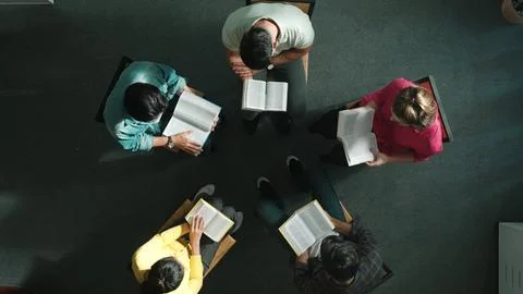 Top down view of prayer reading at bible book and sitting in circle. Symposium. Stock Photos