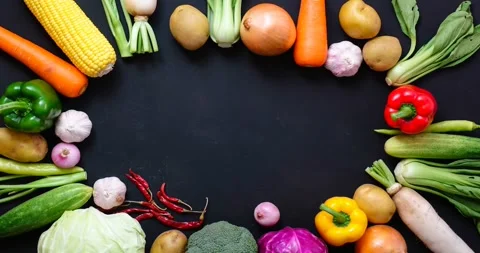 Top Down View of Raw Vegetables Arranged in Circle on Black Stock Footage 337514025