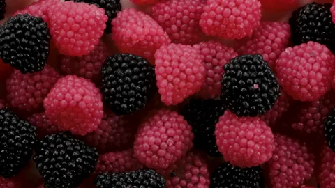 Top down view. Red and black berry marmalade candy. Berry shaped jelly. Видео 296566868
