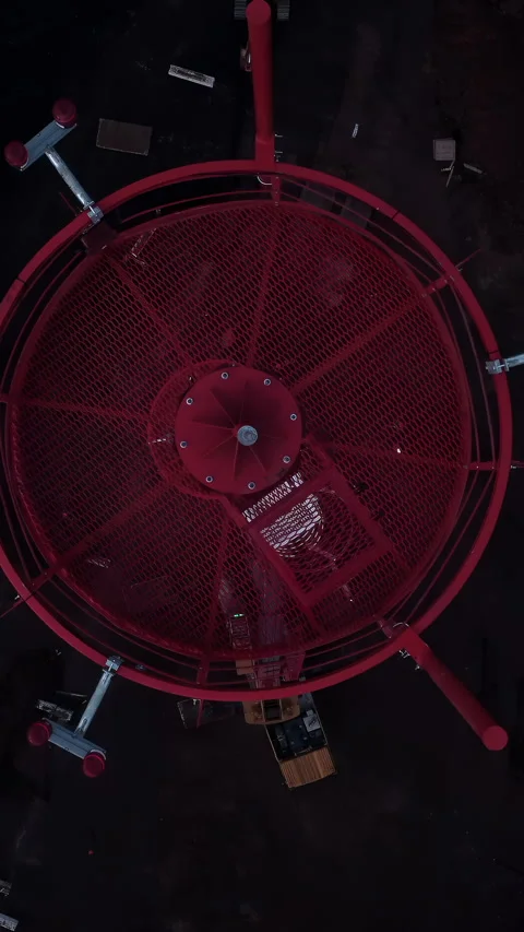 Top-down view of a red circular industrial structure in a dark technical setting Stock Footage 347033032