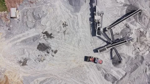Top down view of red loader and stone conveyor at quarry Stock Footage 338221875