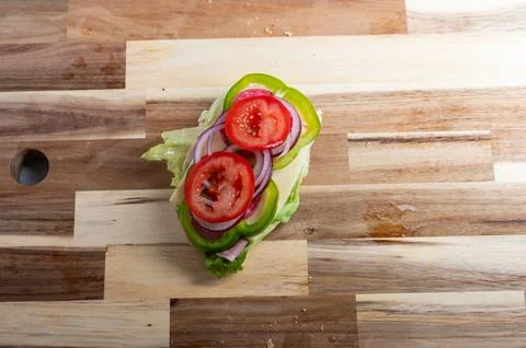 Top-down view of red onion slices on wooden board  food preparation backgroun Stock Photos