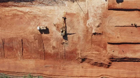 Top-Down View of Red-Soil Excavation and Machinery on Future Housing Site Stock Footage 310460512