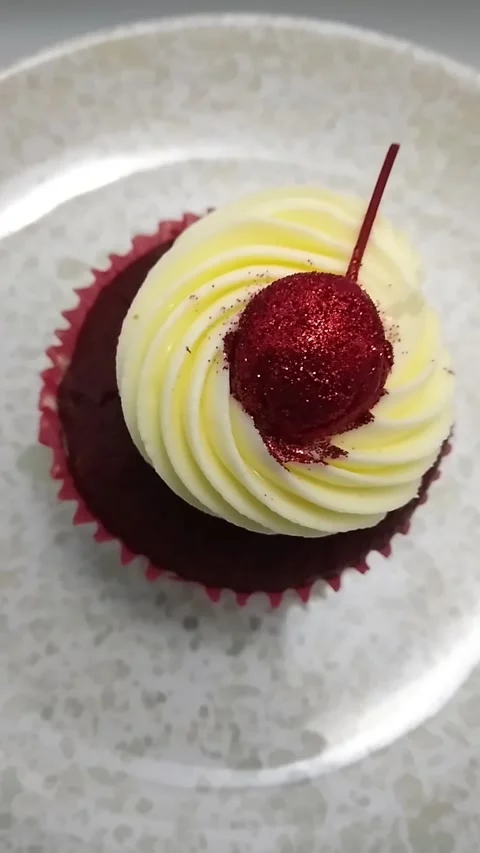 Top Down View of Red Velvet Cupcake topped with Cream Cheese Frosting Stock Footage 327563160