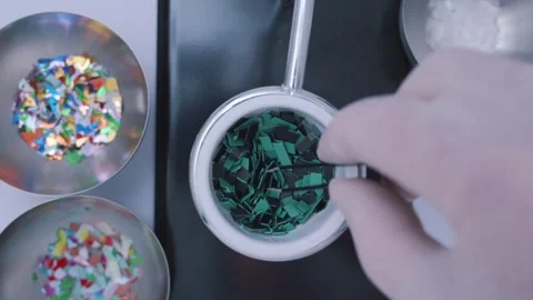 Top down view of a researcher with tweezers selecting microplastic samples for a Stock Footage 331322331