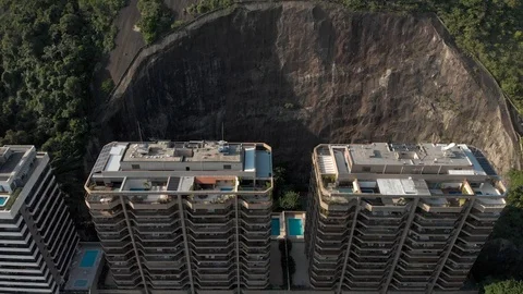 Top down view on residential buildings residing in partly cut out mountain side Stock Footage 105881057