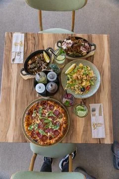 Top-down view of a restaurant table filled with gourmet dishes. Stock-Fotos