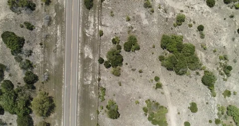 Top down view of road traversing through desolate ground drone aerial 4K Stock Footage 111316808