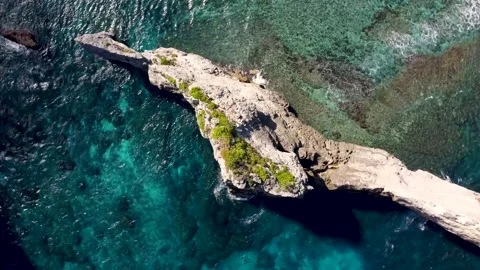 Top down view on rock cliff in ocean orbit Stock Footage 161783049