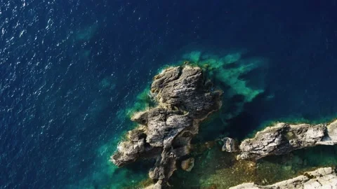 Top down view of rocks in clear blue sea. Video stock 158331317