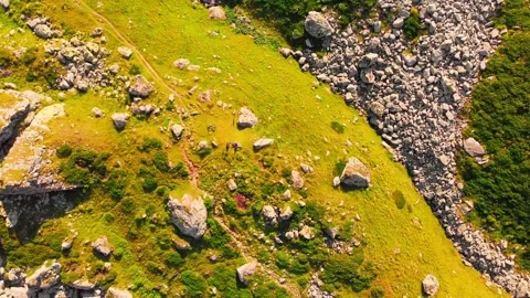 Top down view rocky terrain with grass and hiking trail with no people outdoo Stock Footage 162325009