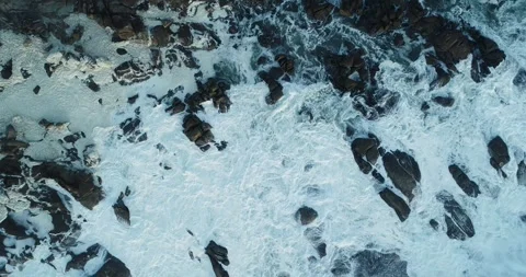 Top down view of rough ocean waves crashing on rocks The Concept of natural.. Stock Footage 336269559