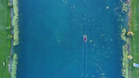 Top down view of a rowing lane on a lake with a boat going by Stock Footage 95195624