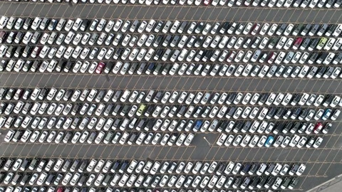 Top down view of rows of new cars parked in parking lot for shipping to dealers Stock Footage 171836915