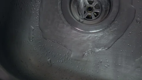 Top down view of running tap in stainless steel sink with water flowing Stock Footage 104782516