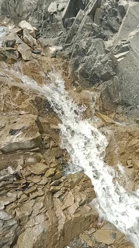 Top down view of rushing waterfall stream over rugged mountain rocks Stock Footage 337102597