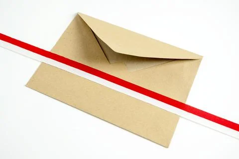 A top-down view of a rustic craft paper envelope decorated with a diagonal .. Stock Photos