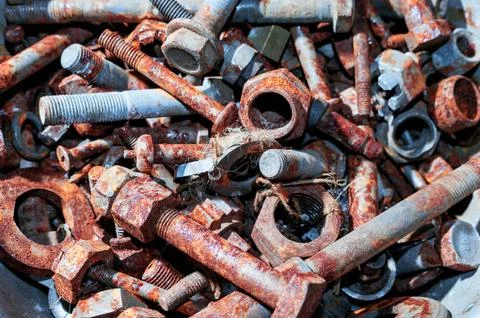 Top Down View Of Rusty Bolts, Nuts, Washers in a Steel Container. Stock Photos